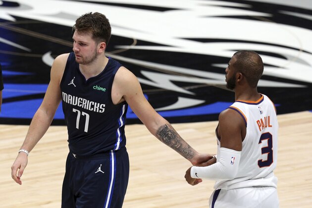 Dallas Mavericks guard Luka Doncic (77) shakes hands with Phoenix Suns guard Chris Paul (3) as he walks off the court after the Mavericks loss in an NBA basketball game, Monday, Feb. 1, 2021, in Dallas. (AP Photo/Richard W. Rodriguez)