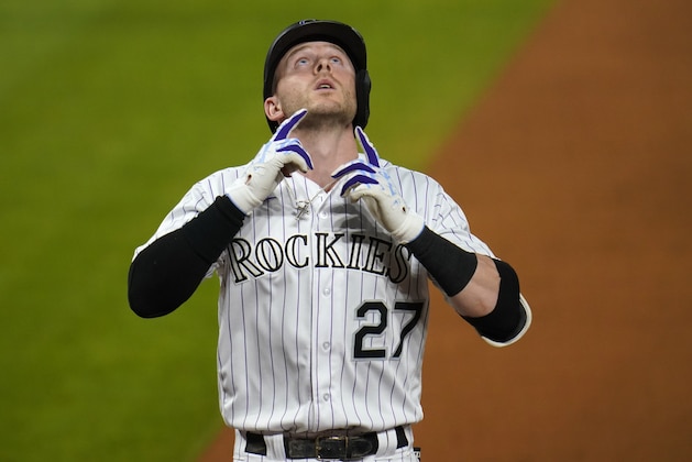 Colorado Rockies' Trevor Story gestures as he crosses home plate after hitting a solo home run off Los Angeles Dodgers relief pitcher Adam Kolarek during the eighth inning of a baseball game Thursday, Sept. 17, 2020, in Denver. The Dodgers won 9-3. (AP Photo/David Zalubowski)