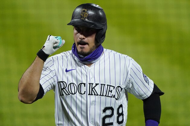Colorado Rockies' Nolan Arenado (28) points to the sky as he celebrates a two run home run against the San Francisco Giants during the sixth inning of a baseball game, Monday Aug. 3, 2020, in Denver. (AP Photo/Jack Dempsey)