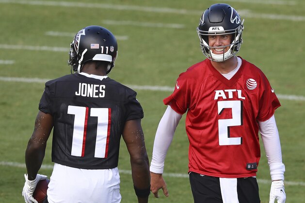 Atlanta Falcons quarterback Matt Ryan shares a laugh with wide receiver Julio Jones after he made a shoe string catch during NFL football training camp on Wednesday, Aug. 19, 2020, in Flowery Branch, Ga. (Curtis Compton/Atlanta Journal-Constitution via AP, Pool)