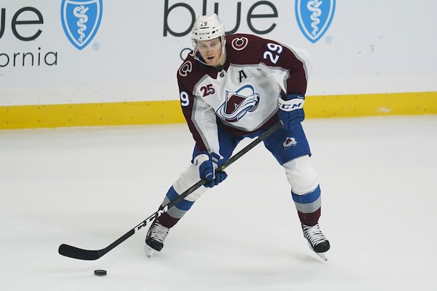 Colorado Avalanche center Nathan MacKinnon (29) controls the puck during the first period of the team's NHL hockey game against the Colorado Avalanche on Thursday, Jan. 21, 2021, in Los Angeles. (AP Photo/Ashley Landis)