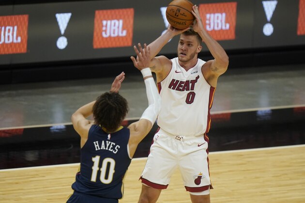 Miami Heat center Meyers Leonard (0) looks for an opening past New Orleans Pelicans center Jaxson Hayes (10) during the first half of a preseason NBA basketball game, Monday, Dec. 14, 2020, in Miami. (AP Photo/Wilfredo Lee)
