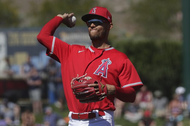 Los Angeles Angels Andrelton Simmons throws abasing the Cleveland Indians during the second inning of a spring training baseball game Monday, March 9, 2020, in Tempe, Ariz. (AP Photo/Matt York)