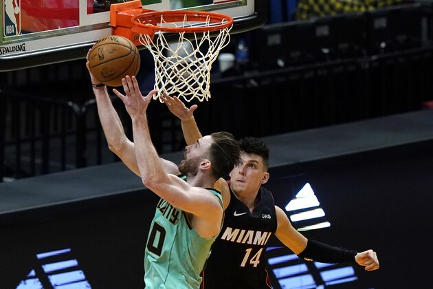 Charlotte Hornets forward Gordon Hayward, left, goes to the basket as Miami Heat guard Tyler Herro (14) defends during overtime in an NBA basketball game, Monday, Feb. 1, 2021, in Miami. The Hornets won 129-121. (AP Photo/Lynne Sladky)