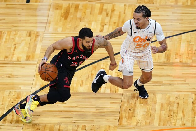 Toronto Raptors guard Fred VanVleet, left, drives around Orlando Magic guard Cole Anthony (50) during the first half of an NBA basketball game, Tuesday, Feb. 2, 2021, in Orlando, Fla. (AP Photo/John Raoux)