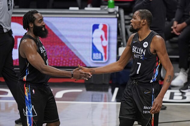 Brooklyn Nets forward Kevin Durant (7) congratulates Brooklyn Nets guard James Harden (13) during the final seconds of the fourth quarter of an NBA basketball game against the Los Angeles Clippers, Tuesday, Feb. 2, 2021, in New York. The Nets defeated the Clippers 124-120. (AP Photo/Kathy Willens)