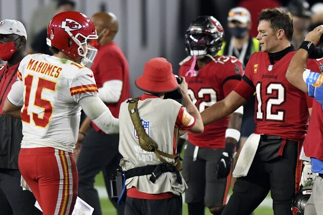 FILE- In this Nov. 29, 2020, file photo, Tampa Bay Buccaneers quarterback Tom Brady (12) congratulates Kansas City Chiefs quarterback Patrick Mahomes (15) after their NFL football game in Tampa, Fla. The Super Bowl matchup features the most accomplished quarterback ever to play the game who is still thriving at age 43 in Brady against the young gun who is rewriting record books at age 25.  (AP Photo/Jason Behnken, File)