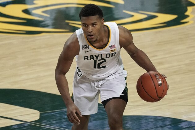 Baylor's Jared Butler (12) brings the ball up the court against Auburn during the second half of an NCAA college basketball game in Waco, Texas, Saturday, Jan. 30, 2021. (AP Photo/Chuck Burton)