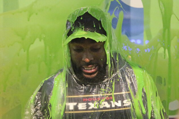 Houston Texans running Back Akeem Hunt gets slimed at the Nickelodeon booth at the NFL Experience on Sunday, January 29, 2017 in Houston, TX. (AP Photo/Gregory Payan)