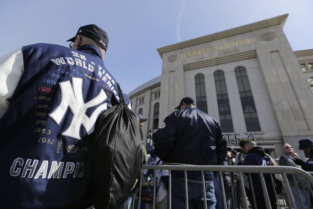 Baseball fans line up outside Yankee Stadium before the start of an opening day baseball game between the New York Yankees and the Baltimore Orioles, Thursday, March 28, 2019, in New York. (AP Photo/Seth Wenig)