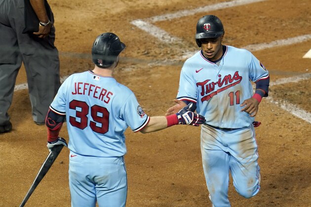 Minnesota Twins' Jorge Polanco, right, is greeted by Ryan Jeffers after Polanco scored on a single by Marwin Gonzalez off Detroit Tigers pitcher Casey Mize during the third inning of a baseball game, Wednesday, Sept. 23, 2020, in Minneapolis. (AP Photo/Jim Mone)
