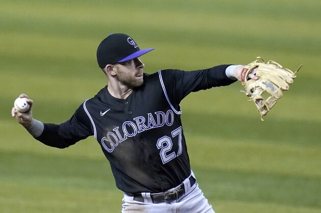 Colorado Rockies shortstop Trevor Story throws to first base against the Arizona Diamondbacks in the first inning during the second game of a baseball doubleheader Friday, Sept. 25, 2020, in Phoenix. (AP Photo/Ross D. Franklin)