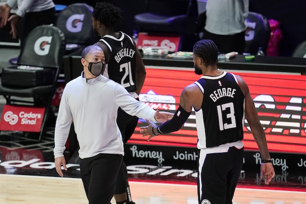 Los Angeles Clippers head coach Tyronn Lue, left, shakes hands with guard Paul George (13) during the second half of an NBA basketball game against the Chicago Bulls Sunday, Jan. 10, 2021, in Los Angeles. (AP Photo/Marcio Jose Sanchez)