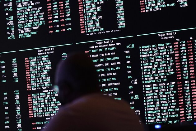 Betting odds for NFL football's Super Bowl 55 are displayed on monitors at the Circa resort and casino sports book, Wednesday, Feb. 3, 2021, in Las Vegas. (AP Photo/John Locher)