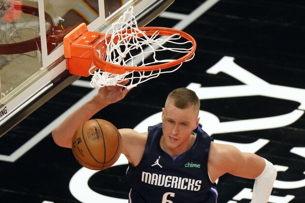 Dallas Mavericks forward Kristaps Porzingis scores against the Atlanta Hawks during the second half of an NBA basketball game Wednesday, Feb. 3, 2021, in Atlanta. (AP Photo/John Bazemore)