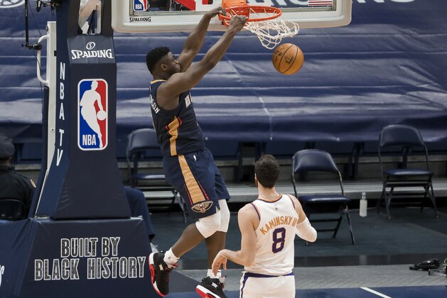 New Orleans Pelicans forward Zion Williamson (1) dunks over Phoenix Suns forward Frank Kaminsky (8) in the third quarter of an NBA basketball game in New Orleans, Wednesday, Feb. 3, 2021. (AP Photo/Derick Hingle)
