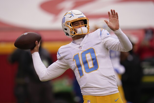 Los Angeles Chargers quarterback Justin Herbert warms up before an NFL football game against the Kansas City Chiefs, Sunday, Jan. 3, 2021, in Kansas City. (AP Photo/Jeff Roberson)