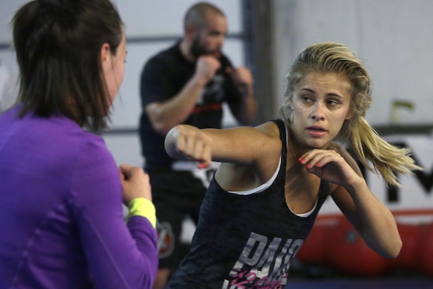 FILE - In this Monday, April 13, 2015, file photo, mixed martial arts fighter Paige VanZant, right, spars with Sarah Jamila at Ultimate Fitness in Sacramento, Calif. VanZant would love to be the next Ronda Rousey in the cage and on the silver screen, but the up-and-coming strawweight UFC fighter realizes she must do plenty of work to catch up to the dominant bantamweight champion. She takes her next step Saturday, Sept. 5, at UFC 191 in Las Vegas against Alex Chambers. (AP Photo/Rich Pedroncelli, File)
