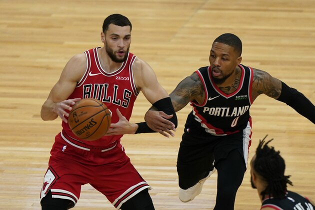 Chicago Bulls guard Zach LaVine, left, looks to pass as Portland Trail Blazers guard Damian Lillard tries to steal the ball during the first half of an NBA basketball game in Chicago, Saturday, Jan. 30, 2021. (AP Photo/Nam Y. Huh)