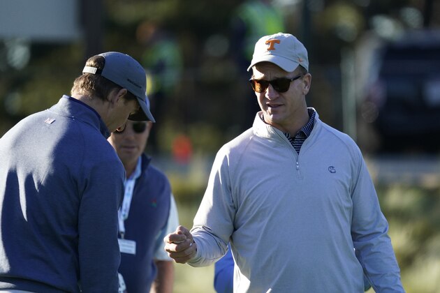 Peyton Manning, right, and Eli Manning prepare to hit from the first tee of the Spyglass Hill Golf Course during the first round of the AT&T Pebble Beach National Pro-Am golf tournament Thursday, Feb. 6, 2020, in Pebble Beach, Calif. (AP Photo/Tony Avelar)