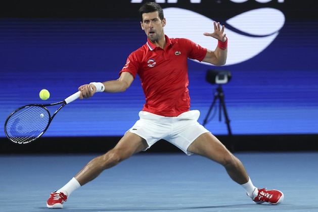Serbia's Novak Djokovic makes a forehand return to Germany's Alexander Zverev during their ATP Cup match in Melbourne, Australia, Friday, Feb. 5, 2021.(AP Photo/Hamish Blair)