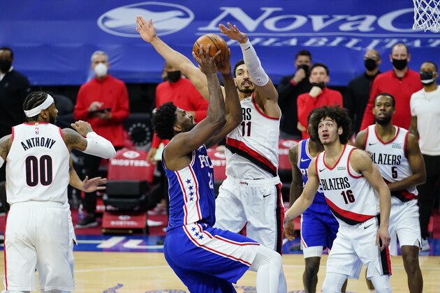 Philadelphia 76ers' Joel Embiid, left, tries to get a shot past Portland Trail Blazers' Enes Kanter during the second half of an NBA basketball game, Thursday, Feb. 4, 2021, in Philadelphia. (AP Photo/Matt Slocum)