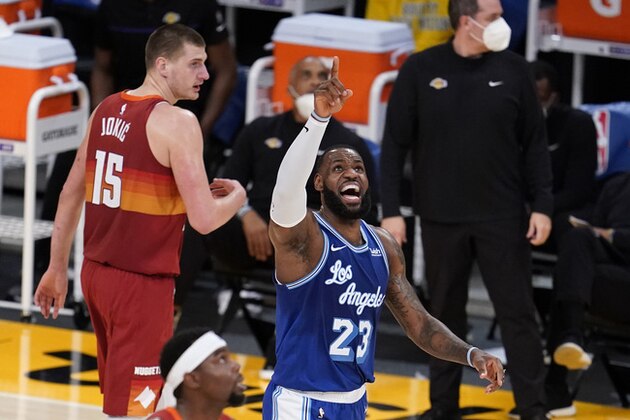 Los Angeles Lakers forward LeBron James (23) argues a call, next to Denver Nuggets center Nikola Jokic (15) during the first half of an NBA basketball game Thursday, Feb. 4, 2021, in Los Angeles. (AP Photo/Marcio Jose Sanchez)