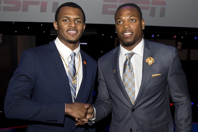 FILE - In this Dec. 10, 2015, file photo, two Heisman Trophy candidates, Clemson quarterback Deshaun Watson, left, and Alabama running back Derrick Henry, pose for a photograph after the college football awards at the College Football Hall of Fame in Atlanta. Faith and football go together at Clemson, as they do at many prominent universities. But perhaps nowhere is the display more overt at a public university than here, where coach Dabo Swinney’s background as a Christian is a prominent part of his and the team’s identity. Watson said his faith played a small part in his deciding to attend Clemson.