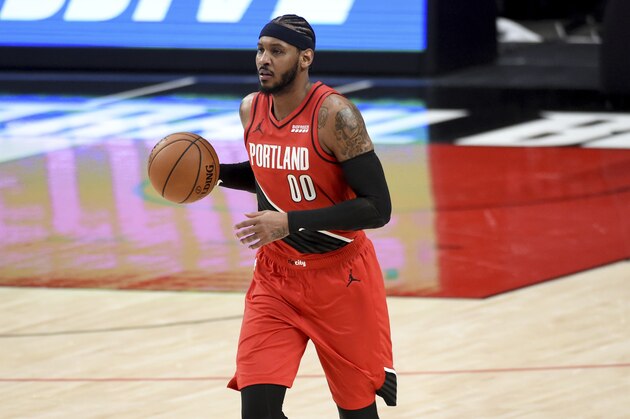 Portland Trail Blazers forward Carmelo Anthony brings the ball up the court during the first half of an NBA basketball game against the Houston Rockets in Portland, Ore., Saturday, Dec. 26, 2020. (AP Photo/Steve Dykes)