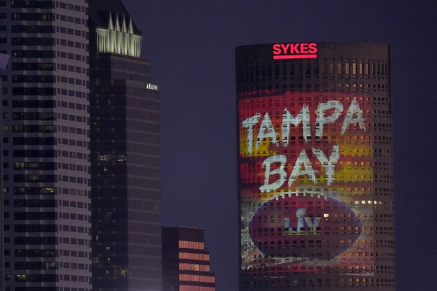 Signage for Super Bowl 55 is projected on a building in downtown Tampa, Fla. Thursday, Feb. 4, 2021. The city is hosting Sunday's Super Bowl NFL football game between the Tampa Bay Buccaneers and the Kansas City Chiefs. (AP Photo/Charlie Riedel)