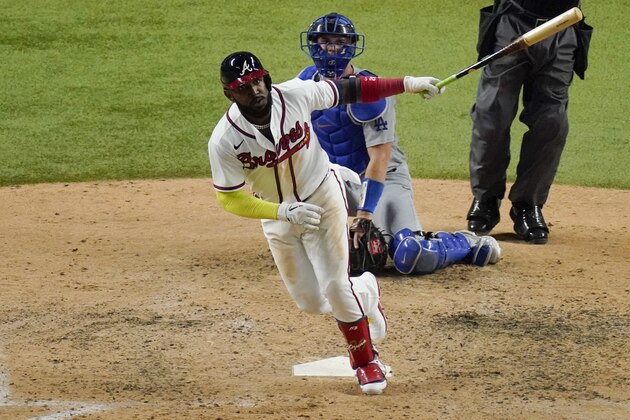 Atlanta Braves' Marcell Ozuna watches his home run against the Los Angeles Dodgers during the seventh inning in Game 4 of a baseball National League Championship Series Thursday, Oct. 15, 2020, in Arlington, Texas.(AP Photo/Sue Ogrocki)
