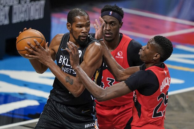 Toronto Raptors' Pascal Siakam (43) and Chris Boucher (25) defend against Brooklyn Nets' Kevin Durant (7) during the first half of an NBA basketball game Friday, Feb. 5, 2021, in New York. (AP Photo/Frank Franklin II)