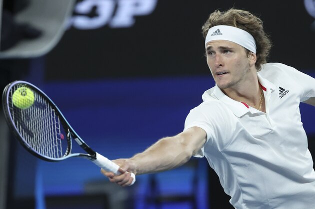 Germany's Alexander Zverev makes a backhand return to Russia's Daniil Medvedev during their ATP Cup semifinal match in Melbourne, Australia, Saturday, Feb. 6, 2021.(AP Photo/Hamish Blair)