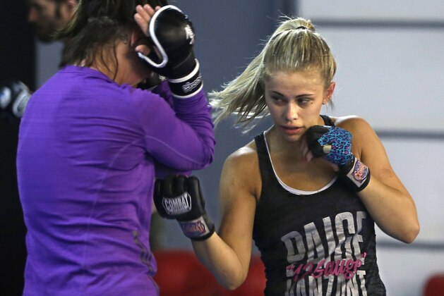 In this Monday, April 13, 2015, photo, mixed martial arts fighter Paige VanZant, right, spars with Sarah Jamila at Ultimate Fitness in Sacramento, Calif. VanZant, 21, is scheduled to fight Felice Herrig in an Ultimate Fighting Championship strawweight match in New Jersey on Saturday. (AP Photo/Rich Pedroncelli)