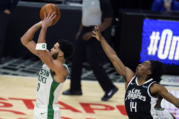 Boston Celtics forward Jayson Tatum, left, shoots next to Los Angeles Clippers guard Terance Mann (14) during the first half of an NBA basketball game Friday, Feb. 5, 2021, in Los Angeles. (AP Photo/Marcio Jose Sanchez)