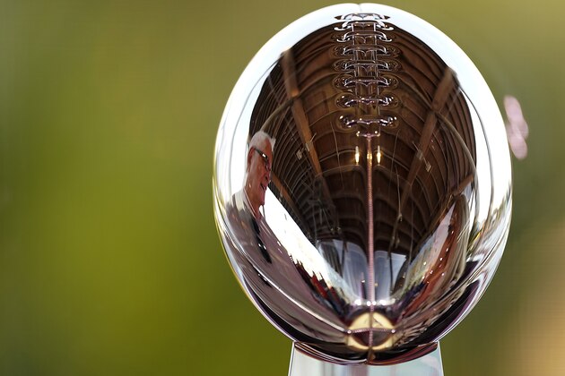 A man looks at the Lombardi Trophy at the NFL Experience Thursday, Feb. 4, 2021, in Tampa, Fla. The city is hosting Sunday's Super Bowl football game between the Tampa Bay Buccaneers and the Kansas City Chiefs. (AP Photo/Charlie Riedel)