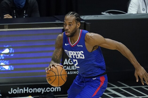 Los Angeles Clippers forward Kawhi Leonard (2) controls the ball during the first quarter of an NBA basketball game against the Sacramento Kings Wednesday, Jan. 20, 2021, in Los Angeles. (AP Photo/Ashley Landis)