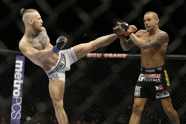 Conor McGregor, left, kicks Dustin Poirier, during their fight, Saturday, Sept. 27, 2014, in Las Vegas. McGregor won via TKO. (AP Photo/John Locher)