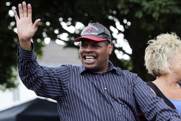 FILE - In this June 12, 2011, file photo, former heavyweight boxing champion Leon Spinks waves during a Boxing Hall of Fame parade in Canastota, N.Y. Leon Spinks is in a Las Vegas hospital after a second operation for abdominal problems. The 61-year-old boxer who catapulted to fame by beating Muhammad Ali in 1978 had the second surgery in recent days after complications from the first emergency surgery. (AP Photo/Mike Groll, File)