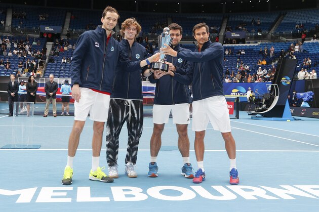 Russia's ATP Cup winners Daniil Medvedev, Andrey Rublev, Aslan Karatsev and Evgeny Donsky pose with their trophy after defeating Italy in the final in Melbourne, Australia, Sunday, Feb. 7, 2021.(AP Photo/Hamish Blair)
