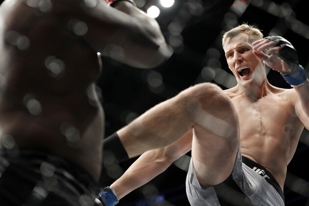 Alexander Volkov kicks Derrick Lewis during a heavyweight mixed martial arts bout at UFC 229 in Las Vegas, Saturday, Oct. 6, 2018. (AP Photo/John Locher)