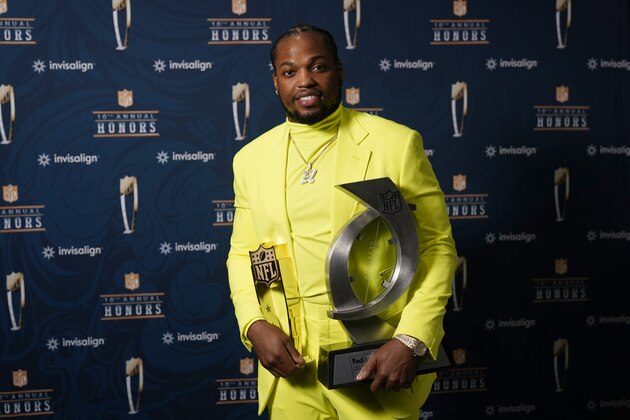 Tennessee Titians running back Derrick Henry poses with his Offensive Player of the Year and his FedEx Ground Player of the Year awards during the NFL Honors ceremony as part of Super Bowl 55 Friday, Feb. 5, 2021, in Tampa, Fla. (AP Photo/Charlie Riedel)
