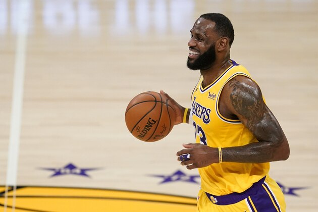 Los Angeles Lakers forward LeBron James smiles as he dribbles the ball during the first half of the team's NBA basketball game against the Detroit Pistons on Saturday, Feb. 6, 2021, in Los Angeles. (AP Photo/Marcio Jose Sanchez)