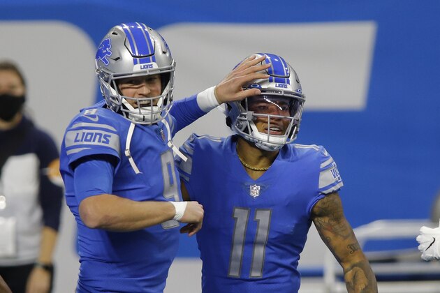 Detroit Lions quarterback Matthew Stafford (9) pats wide receiver Marvin Jones (11) after Jones' touchdown during the first half of an NFL football game against the Minnesota Vikings, Sunday, Jan. 3, 2021, in Detroit. (AP Photo/Al Goldis)