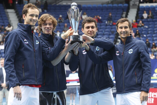 Russia's ATP Cup winners Daniil Medvedev, Andrey Rublev, Aslan Karatsev and Evgeny Donsky pose with their trophy after defeating Italy in the final in Melbourne, Australia, Sunday, Feb. 7, 2021.(AP Photo/Hamish Blair)