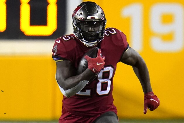 Tampa Bay Buccaneers running back Leonard Fournette (28) runs with the ball against the Washington Football Team during the first half of an NFL wild-card playoff football game, Saturday, Jan. 9, 2021, in Landover, Md. Tampa Bay won 31-23. (AP Photo/Julio Cortez)