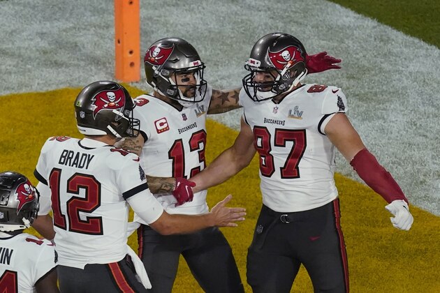 Tampa Bay Buccaneers quarterback Tom Brady (12) congratulates Rob Gronkowski (87) after scoring a touchdown during the first half of the NFL Super Bowl 55 football game against the Kansas City Chiefs, Sunday, Feb. 7, 2021, in Tampa, Fla. (AP Photo/Charlie Riedel)