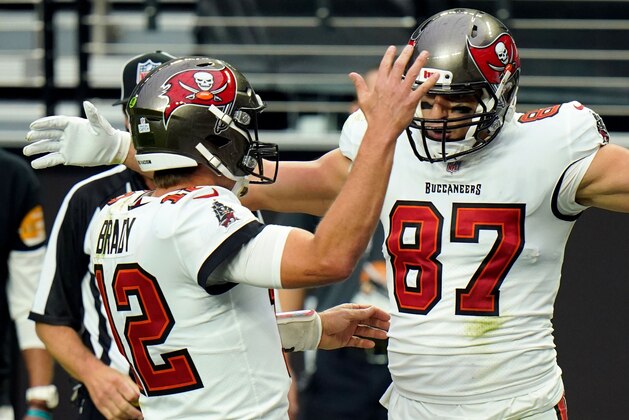 FILE - In this Oct. 25, 2020, file photo, Tampa Bay Buccaneers tight end Rob Gronkowski (87) celebrates with quarterback Tom Brady (12), left, after scoring a touchdown against the Las Vegas Raiders during the first half of an NFL football game in Las Vegas. Gronkowski is one of 218 players to appear in a Super Bowl as Brady's teammate, a number that will grow by more than 40 this week when Brady makes his record 10th trip to to the title game. (AP Photo/Jeff Bottari, File)