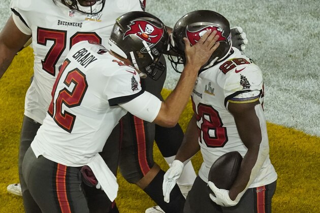Tampa Bay Buccaneers' Leonard Fournette (28) celebrates his touchdown run with quarterback Tom Brady (12) during the second half of the NFL Super Bowl 55 football game against the Kansas City Chiefs, Sunday, Feb. 7, 2021, in Tampa, Fla. (AP Photo/Charlie Riedel)