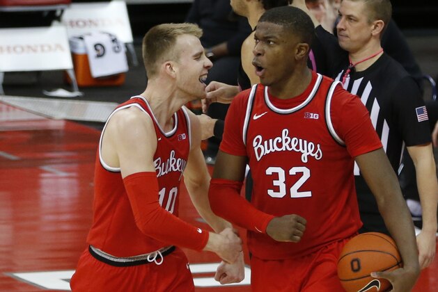 Ohio State's E.J. Liddell, right, celebrates grabbing with teammate Justin Ahrens during the second half of an NCAA college basketball game Wednesday, Jan. 27, 2021, in Columbus, Ohio. Ohio State beat Penn State 83-79. (AP Photo/Jay LaPrete)